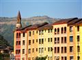 Colourful Bulding with Hill at Background.